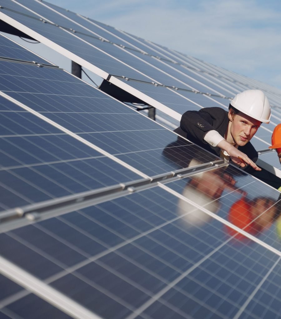 Businessman and worker near solar energy batteries. Business client showing photovoltaic detail to foreman. Two men making deal.